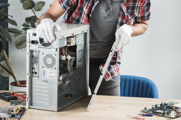 midsection-view-male-technician-assembling-computer-wooden-desk_23-2147922345