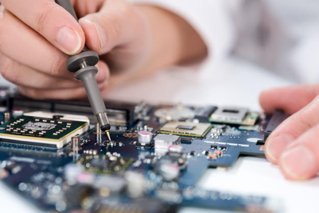 technological-background-with-closeup-tester-checking-motherboard_87646-2361